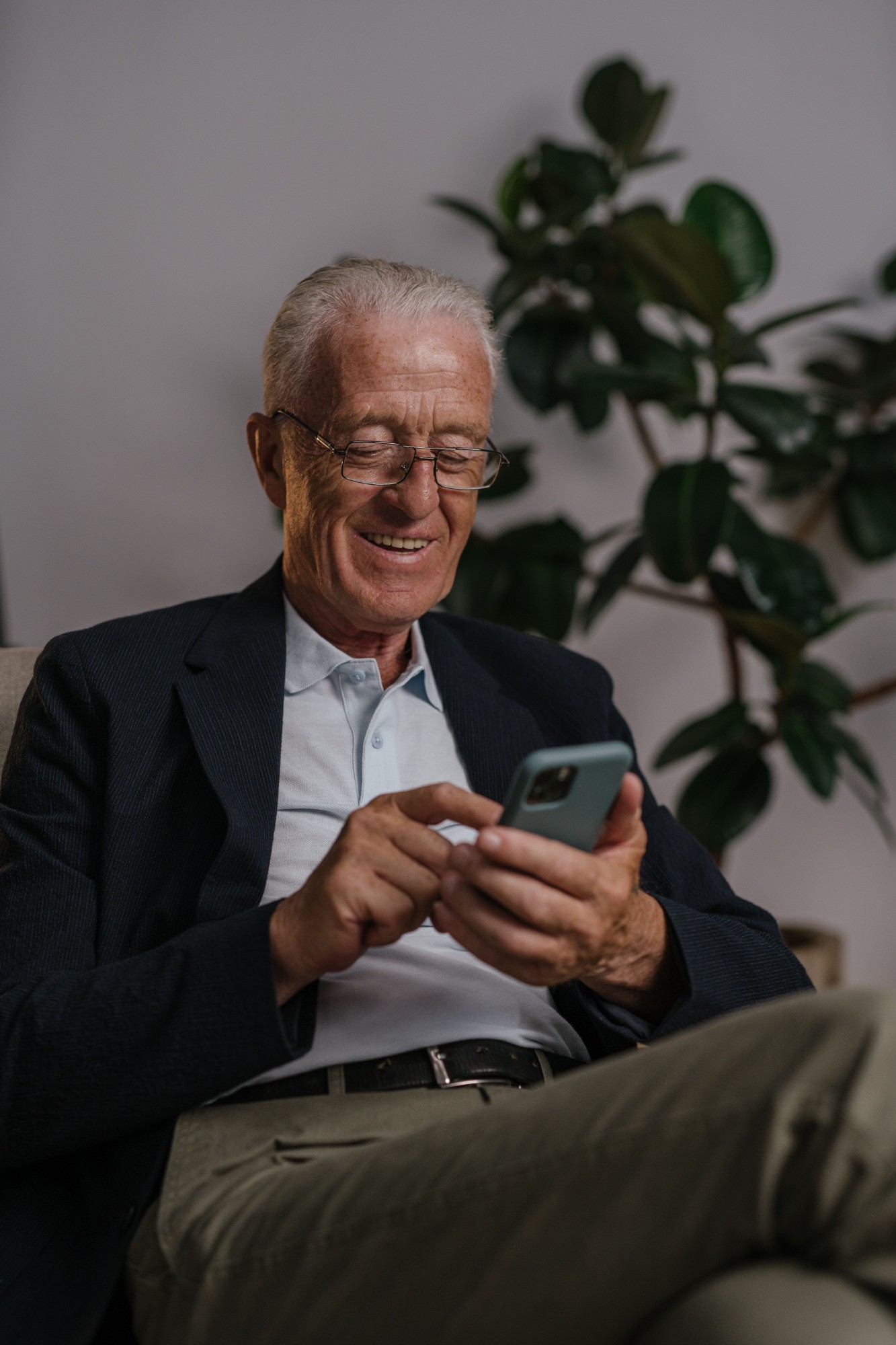 An older man in a therapy session by phone from his living room
